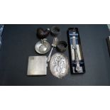 An engine turned silver cigarette case and other silver and metal items.