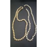 Two simulated pearl single strand necklaces.