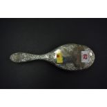 A silver hair brush, having floral scroll decoration and engraved Fanny,