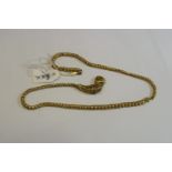 A Victorian unmarked yellow metal snake clasp necklace set cabochon garnet eyes and four baguette