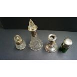 A green glass scent bottle having screw on silver lid,