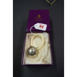 A cased silver teething ring, by Asprey, London 1987, in outer card box.