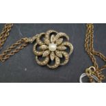 A 9ct gold floral pendant/brooch on 9ct gold necklace chain, total weight 10g.