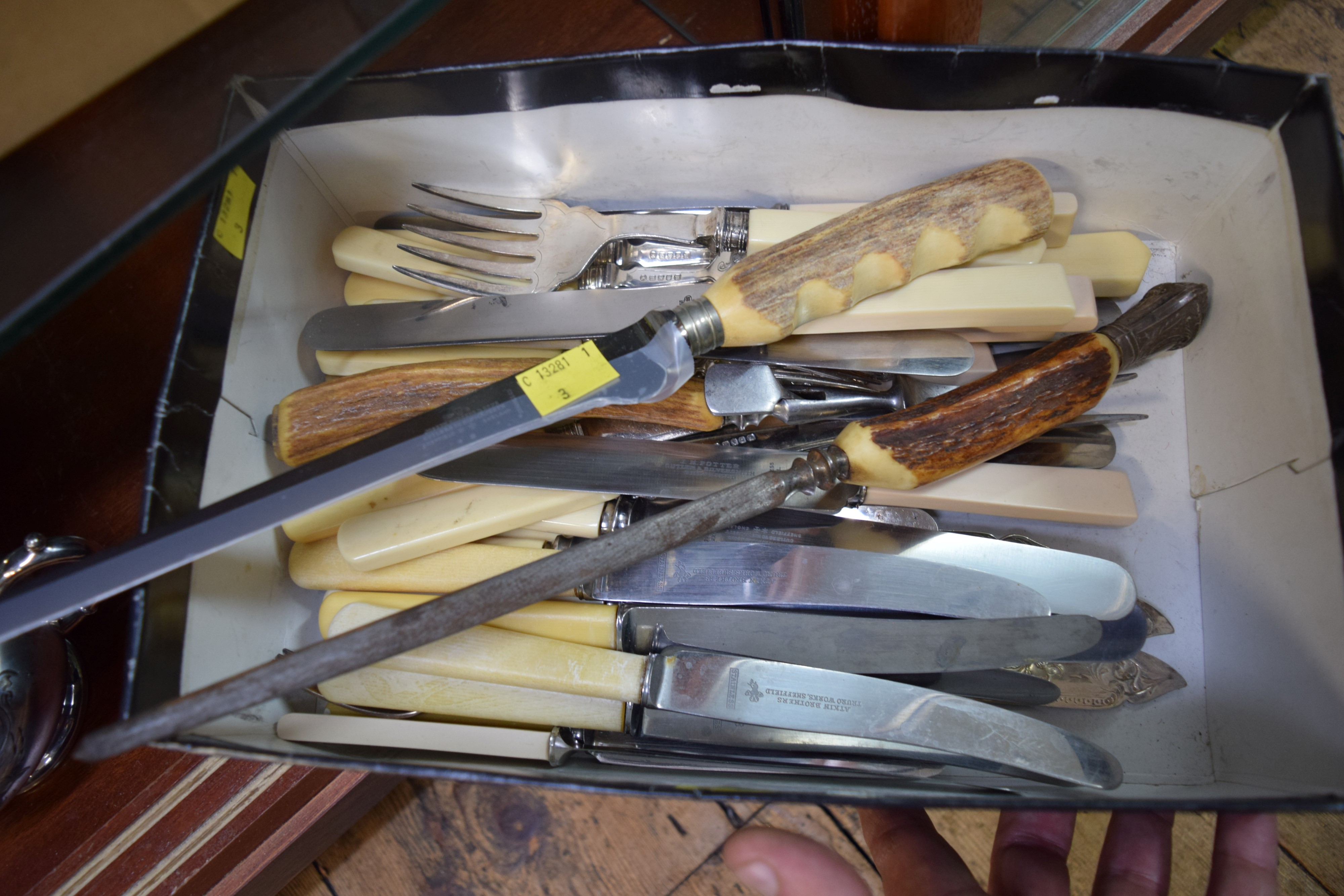 A quantity of bone handled knives and other cutlery.
