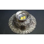 A burnished white metal fruit bowl, having floral decoration, 23.