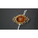 A 9ct gold and amber cabochon brooch, in original box.