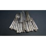 Thirteen silver handled tea knives and three forks.