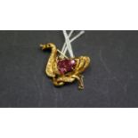 An unmarked yellow metal duck brooch, set diamonds and rubies, 2.5cm.