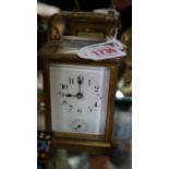 An antique gilt brass carriage clock, with bell striking alarm, height including handle 14.