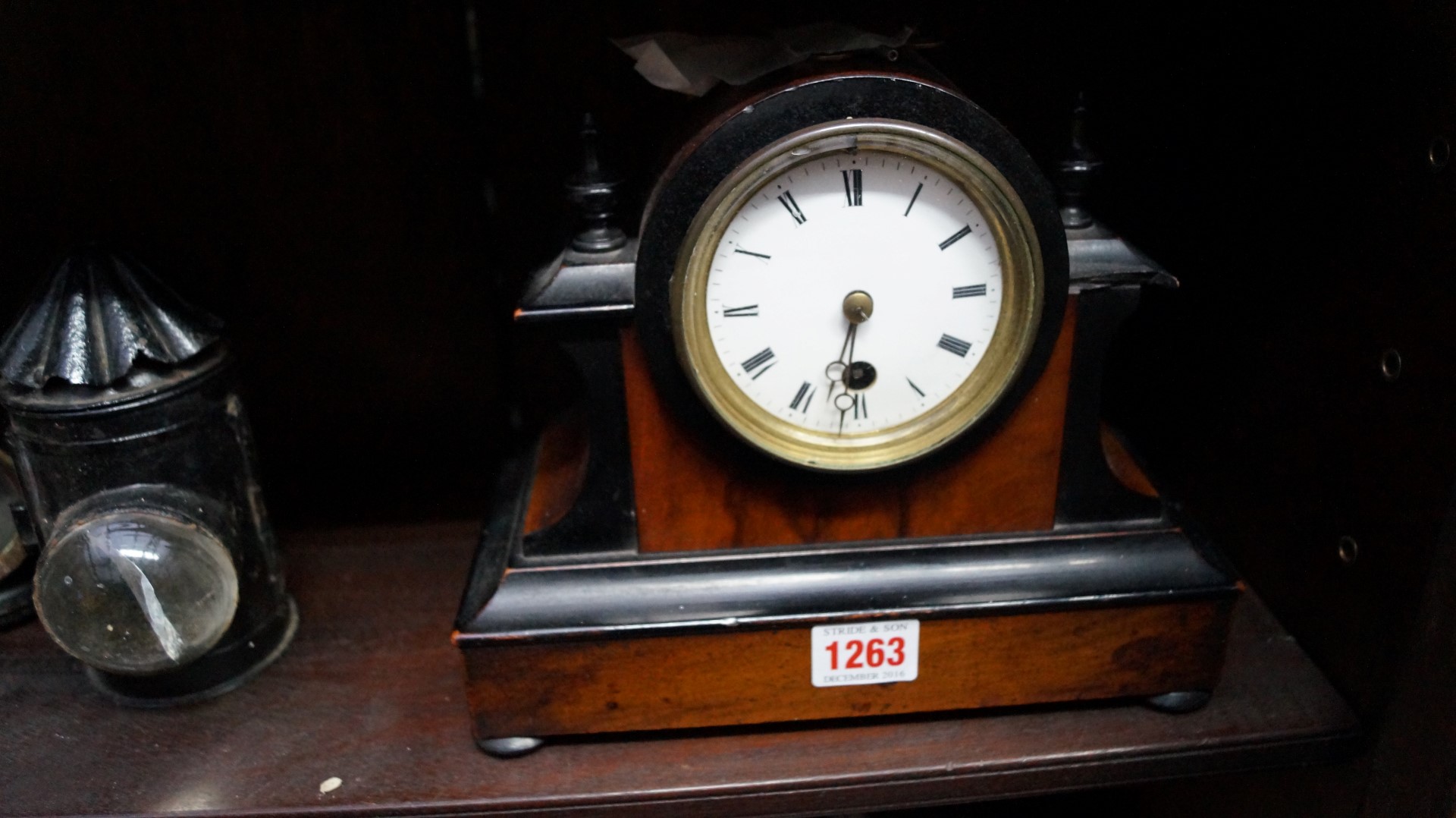 A late Victorian walnut and ebonized mantel timepiece, 23.5cm wide.