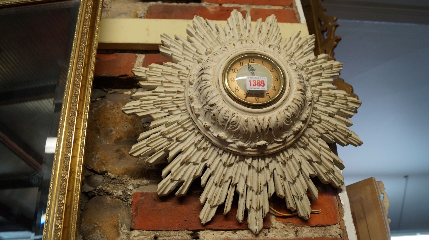 A Smith's grey painted and parcel gilt starburst timepiece, 45cm wide.