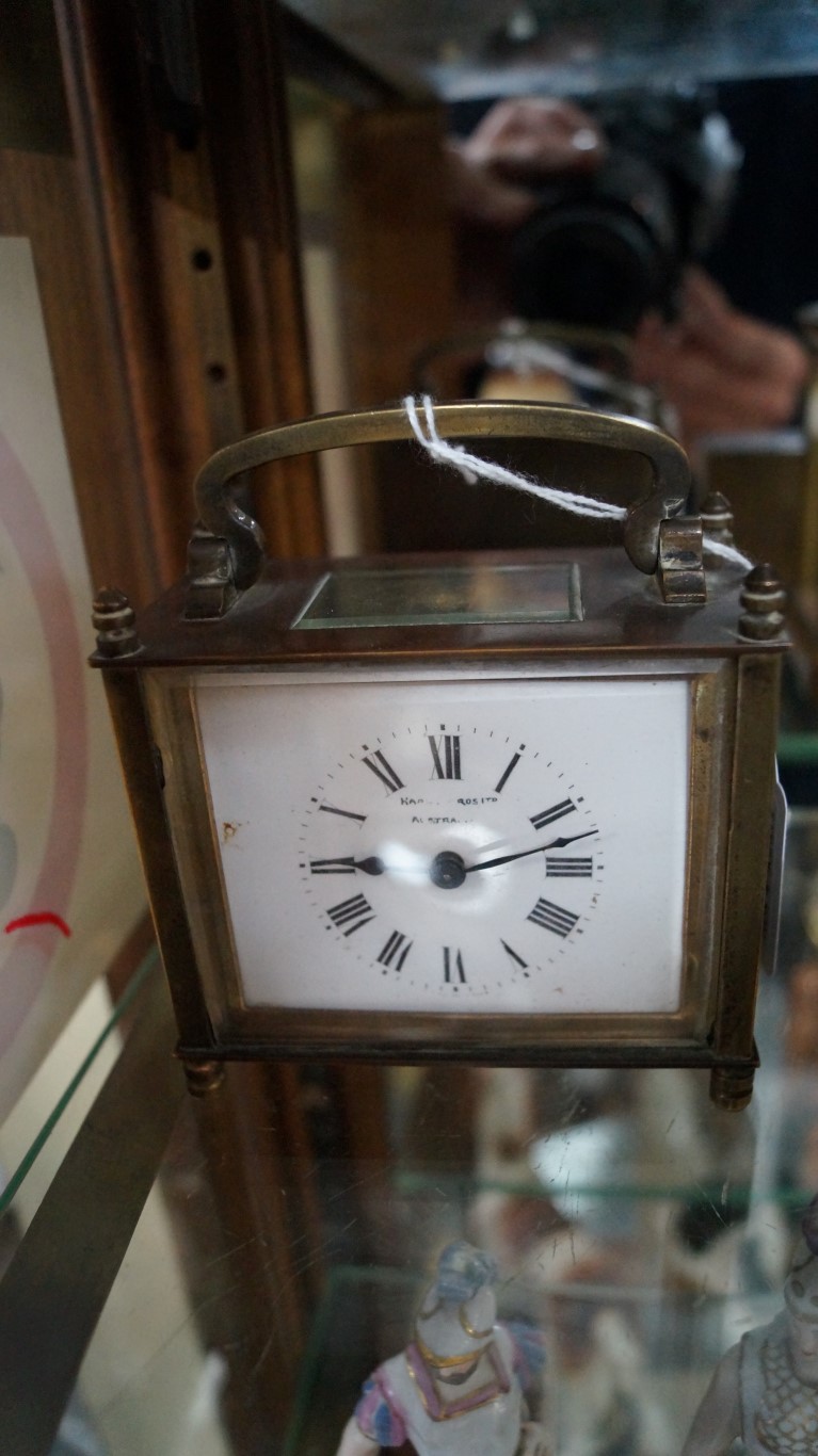 An old brass carriage timepiece, height including handle 11cm.