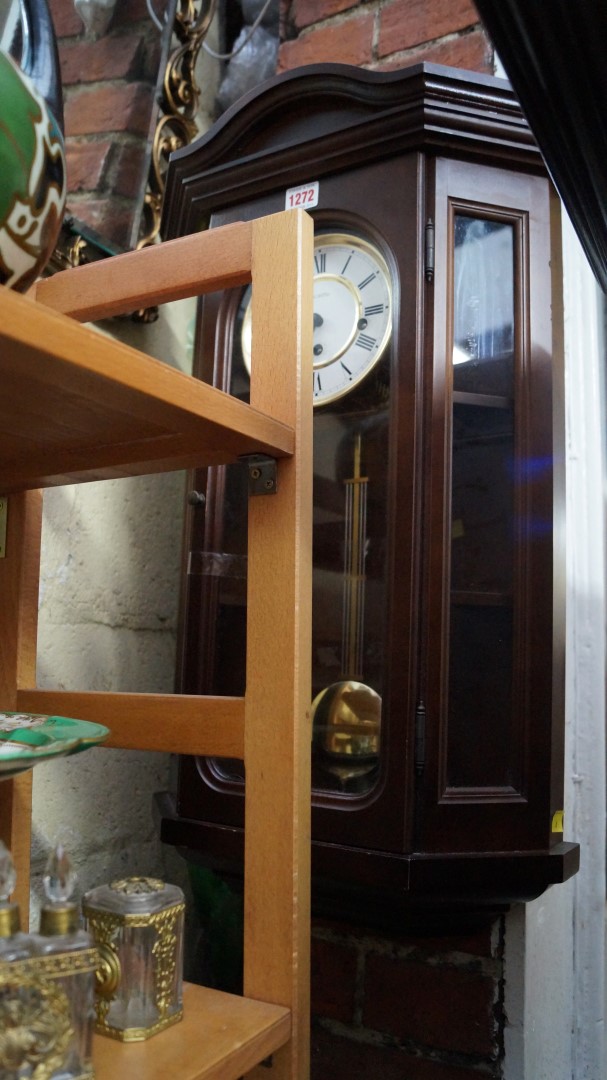 A reproduction mahogany wall clock.