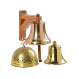 A collection of three bells including a Muster bell from R.A.F. Credenhill on wooden bracket the