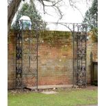 A wrought iron entranceway early 20th century 230cm.; 91ins high by 249cm.; 98ins long by 56cm.;