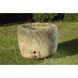 A circular carved limestone trough 78cm.; 31ins high by 100cm.; 39½ins diameter