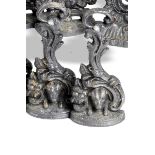 A pair of cast iron doorstops mid 19th century cast with foliage and dogs' heads 27cm.; 10½ins high