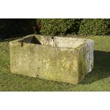 A rectangular carved limestone trough 71cm.; 28ins high by 156cm.; 61ins long by 98cm.; 38½ins deep