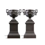 Garden Urns: A pair of monumental Val d’Osne foundry cast iron urns on pedestalsFrench, circa