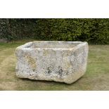 Water Feature: A rectangular carved stone trough 56cm.; 22ins high by 115cm.; 45ins long by 80cm.;