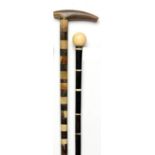Walking Canes: A horn stick late 19th century 86cm; 34ins long and another horn cane with ivory top