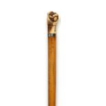 Walking sticks: A Malacca cane early 19th century with clenched fist ivory top and mother of pearl