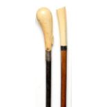 Walking sticks: A late Victorian hardwood cane with ivory top inscribed M.N. Hodgson 84cm.; 33ins