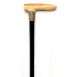 Walking canes: A Victorian ebony stick with ivory handle and gilt metal embossed collar circa 1870