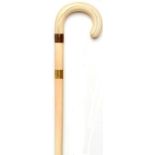 Walking canes: A Victorian ivory stick with gilt metal collar late 19th century 86cm.; 34ins long