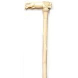 Walking canes: An ivory walking stick, the handle carved with a lion Indian, circa 1900 94cm.; 37ins