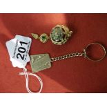 Gold and emerald brooch and gold key ring enscribed lamborghini