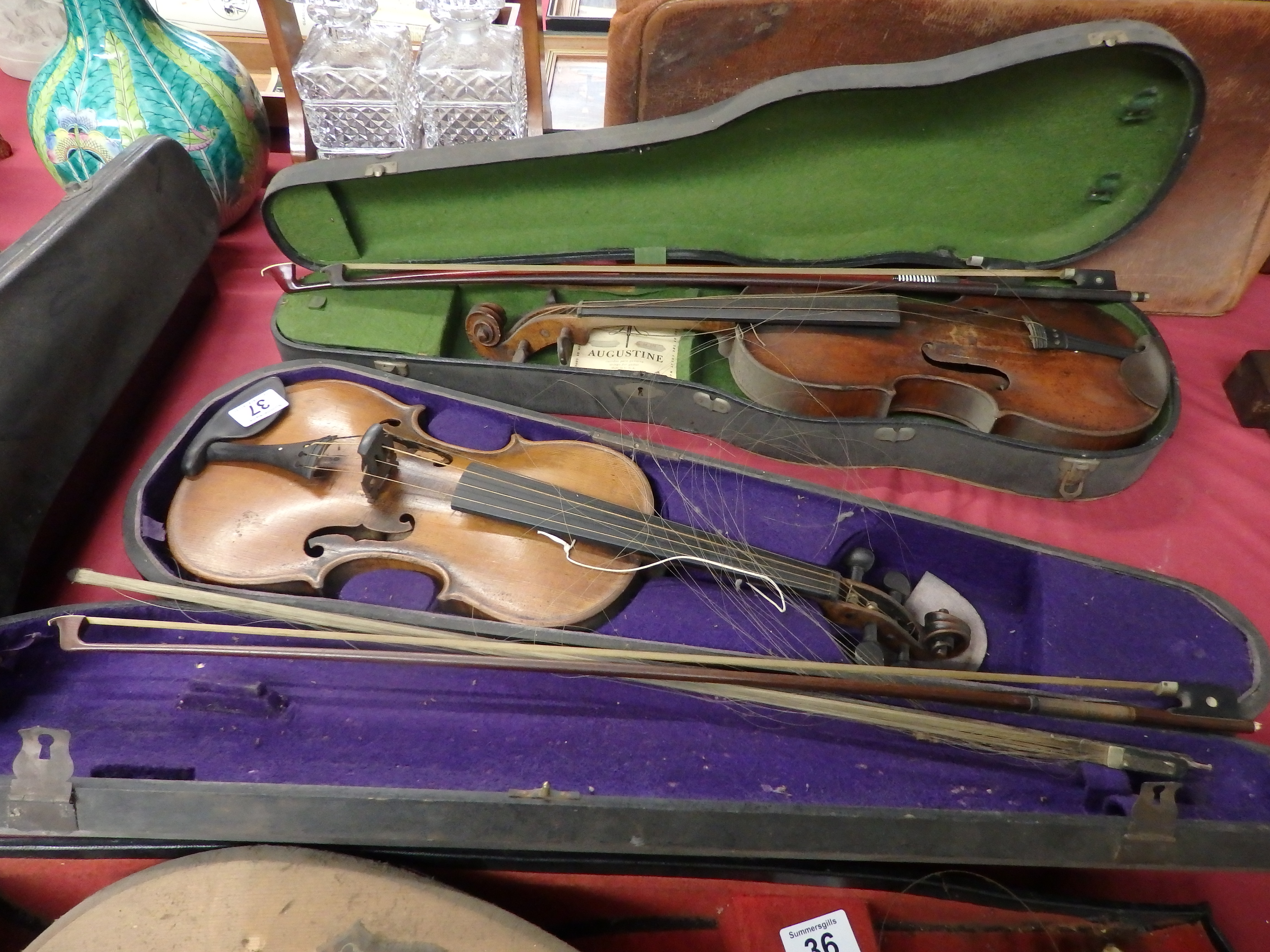 2 Violins in cases with 4 bows 1 marked Wolff bros. 1881