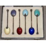 A BOXED SET OF HALLMARKED SILVER AND ENAMEL TEASPOONS Each spoon having a shell design to bowl, with