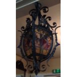 A 20TH CENTURY FRENCH CAST IRON AND LEADED GLASS LANTERN The scrolling ironwork holding elliptical