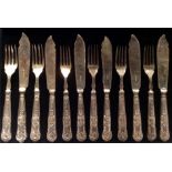 A SET OF SIX EARLY 20TH CENTURY HALLMARKED SILVER HANDLED FISH KNIVES AND FORKS With relief