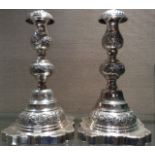 A PAIR OF EDWARDIAN HALLMARKED SILVER CANDLESTICKS With fluted sconces, engraved decoration and a