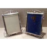 A PAIR OF EDWARDIAN HALLMARKED SILVER PICTURE FRAMES With bevelled glass insets, inclined sides