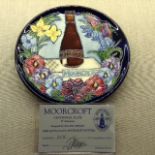 WILLIAM MOORCROFT POTTERY, A LATE 20TH CENTURY LIMITED EDITION YEAR PLATE With a blue ground and