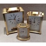 A COLLECTION OF THREE MODERN BRASS CARRIAGE CLOCKS Two rectangular and one cylindrical, with