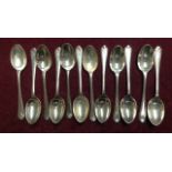 A SET OF TWELVE HALLMARKED SILVER GOLF SPOONS Each having a crossed pair of golf clubs and ball