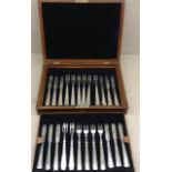 AN ART DECO HALLMARKED SILVER SET OF TWELVE FRUIT KNIVES AND FORKS Each having triangular handles,