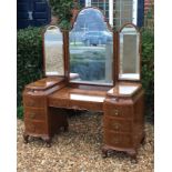 A MID 20TH CENTURY BURR WALNUT DRESSING TABLE With a triptych mirror above an arrangement of