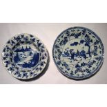 TWO 18TH CENTURY CHINESE EXPORT PORCELAIN BLUE AND WHITE DISHES The large hand painted with