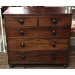 A VICTORIAN MAHOGANY CHEST  Of two short above three long drawers, applied with circular handles and
