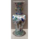 AN 18TH CENTURY CHINESE FAMILLE VERTE PORCELAIN VASE Having a tapering fluted shape with a flared