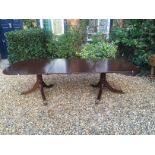 A REGENCY DESIGN MAHOGANY TWIN PEDESTAL DINING TABLE With two extra leaves. (249cm x 117cm)