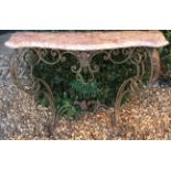 A WROUGHT IRON CONSOLE TABLE WITH PINK VEINED MARBLE TOP Of serpentine shape seated on a base of