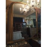 A VICTORIAN GILT FRAMED ROPETWIST OVERMANTEL MIRROR With arched silvered plate. (120cm x 145cm)