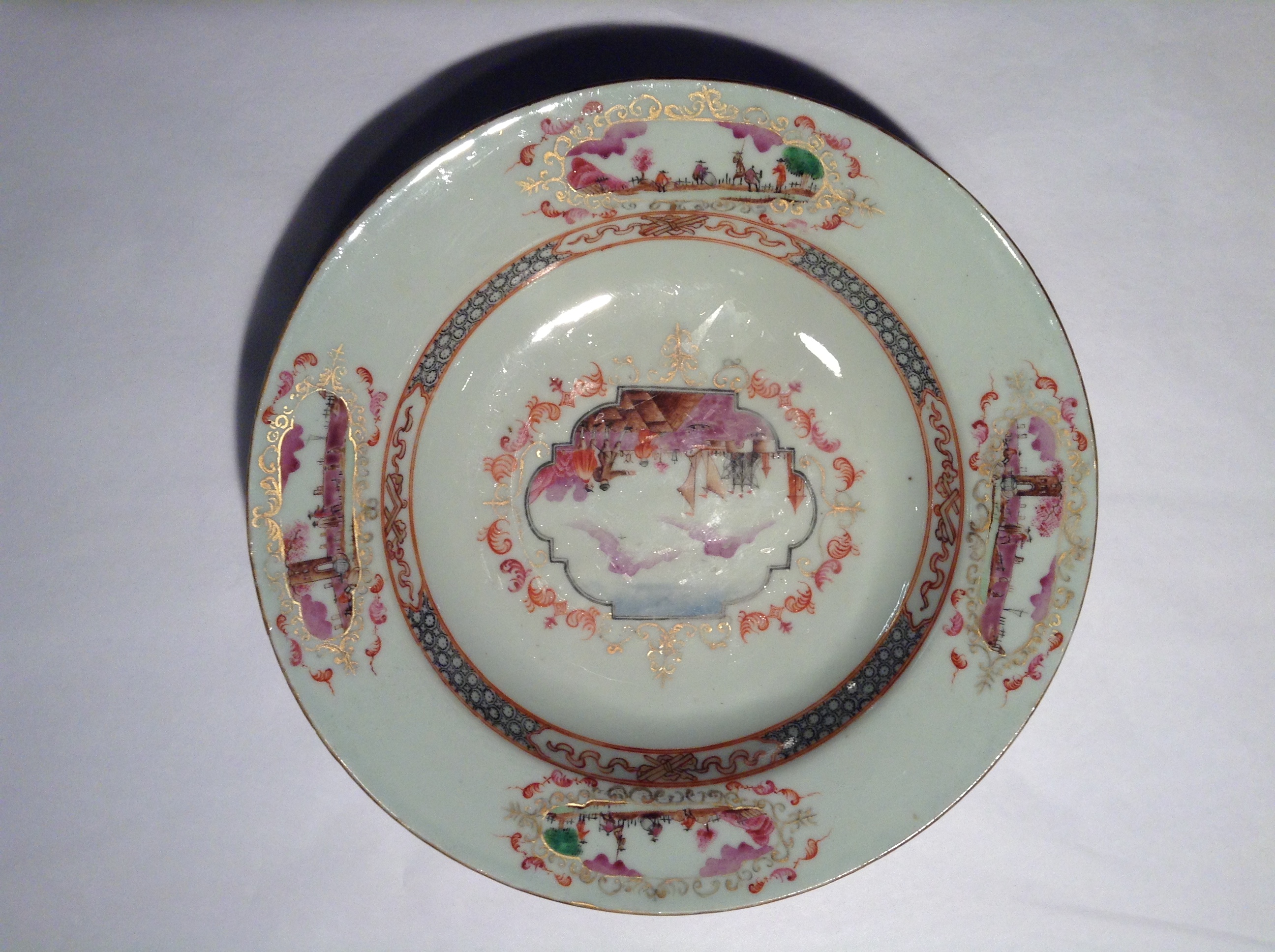 AN 18TH CENTURY CHINESE EXPORT FAMILLE ROSE PORCELAIN DISH The central panel printed with a Dutch