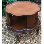 AN EARLY 20TH CENTURY MAHOGANY BOOK TABLE The leather inset shaped top, above an open